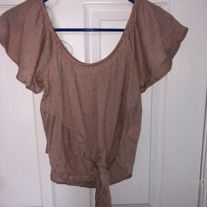 light pink top with knot off the shoulder